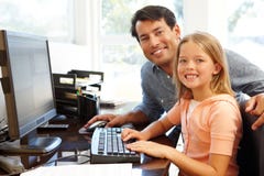 Father and daughter using computer in home office Stock Photography Father and daughter using computer in home office Stock Photography