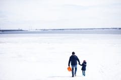 Father with daugther walking on frozen river panoramic view stock photo Father with daugther walking on frozen river panoramic view stock photo
