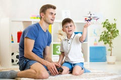 Father and his son play with RC helicopter toy stock photos Father and his son play with RC helicopter toy stock photos