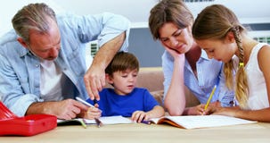 Father and mother helping children with homework stock video Father and mother helping children with homework stock video
