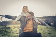 Father playing with his daughter in the park. Daughter lying on royalty free stock images Father playing with his daughter in the park. Daughter lying on royalty free stock images