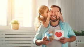 Father`s Day. Happy Family Daughter Hugging Dad And Laughs Stock Photo