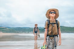 Father and son backpacker travelers walk on sand ocean beach royalty free stock photo Father and son backpacker travelers walk on sand ocean beach royalty free stock photo