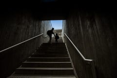 Father and son climbing stairs in pedestrian subway Stock Photos Father and son climbing stairs in pedestrian subway Stock Photos