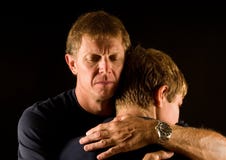 Father and son in emotional hug