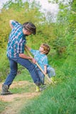 Father and son planting family tree. rich natural soil. Eco farm. Ranch. small boy child help father in farming. new stock photos Father and son planting family tree. rich natural soil. Eco farm. Ranch. small boy child help father in farming. new stock photos