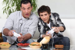 Father and son playing computer games royalty free stock photos Father and son playing computer games royalty free stock photos