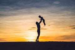 Father and son at the red desert at dawn. Traveling with children concept royalty free stock image Father and son at the red desert at dawn. Traveling with children concept royalty free stock image
