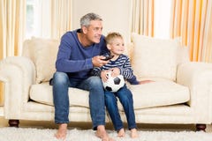 Father and son watching football match on tv royalty free stock image Father and son watching football match on tv royalty free stock image