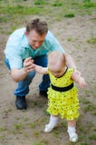 The father teaches the child to walk stock image The father teaches the child to walk stock image
