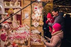 Father and two daughters on Christmas Market at St. Stephen& x27;s Square in front of the St. Stephen& x27;s Basilica. stock photo Father and two daughters on Christmas Market at St. Stephen& x27;s Square in front of the St. Stephen& x27;s Basilica. stock photo
