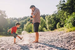 Father and two sons having fun outdoors stock photo Father and two sons having fun outdoors stock photo