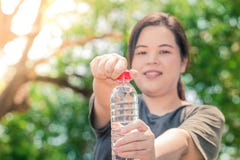 Fatty asian white girl hold clean water bottle royalty free stock image Fatty asian white girl hold clean water bottle royalty free stock image