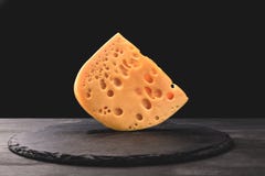 Feche acima do tiro do queijo do emmental a bordo no preto imagem de stock Feche acima do tiro do queijo do emmental a bordo no preto imagem de stock