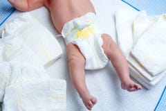 Feet of newborn baby on changing table with diapers stock photos Feet of newborn baby on changing table with diapers stock photos