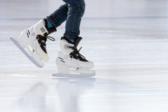 Feet on the skates of a person rolling on the ice rink Royalty Free Stock Photos Feet on the skates of a person rolling on the ice rink Royalty Free Stock Photos