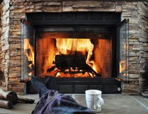 Relaxing in front of a fireplace stock images Relaxing in front of a fireplace stock images