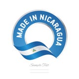 Feito na bandeira azul do botão da etiqueta da cor da bandeira de Nicarágua ilustração stock Feito na bandeira azul do botão da etiqueta da cor da bandeira de Nicarágua ilustração stock
