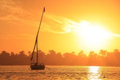 Felucca boat sailing on the Nile river at sunset, Luxor Stock Images Felucca boat sailing on the Nile river at sunset, Luxor Stock Images