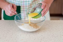 Female Adding Butter To Crushed Biscuits stock photo Female Adding Butter To Crushed Biscuits stock photo