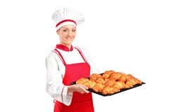 A female baker holding freshly baked croissants stock photo A female baker holding freshly baked croissants stock photo