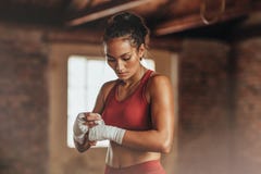 Female boxer wearing strap on wrist stock photo Female boxer wearing strap on wrist stock photo