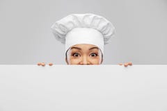 female chef peeking out from behind white board