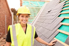 Female Construction Worker On Site Laying Slate Tiles stock photos Female Construction Worker On Site Laying Slate Tiles stock photos
