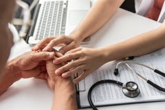 Female doctor holding hands of senior male patient. Royalty Free Stock Photos Female doctor holding hands of senior male patient. Royalty Free Stock Photos