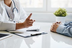 Female doctor warns her patient with a raised finger stock photo Female doctor warns her patient with a raised finger stock photo