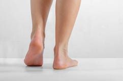 Female feet, feet stand on a white background, Smooth skin, foot care