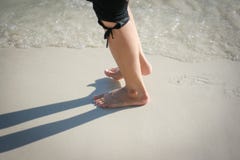 Female feet are walking on the beach royalty free stock image Female feet are walking on the beach royalty free stock image