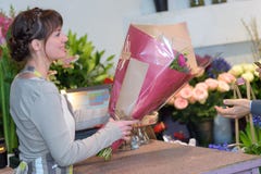 Female florist giving bouquet to client royalty free stock photography Female florist giving bouquet to client royalty free stock photography