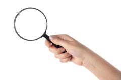 Female hand holding the magnifying glass (isolated