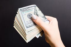 Female Hand Holding Tightly A Bundle Of Money. Top View Of One Hundred And Different Dollars On Colorful Background. Investment Royalty Free Stock Photography Female Hand Holding Tightly A Bundle Of Money. Top View Of One Hundred And Different Dollars On Colorful Background. Investment Royalty Free Stock Photography