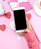 Female hand holding white smart phone with blank black screen stock image Female hand holding white smart phone with blank black screen stock image