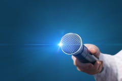Female hand with microphone . Stock Photo Female hand with microphone . Stock Photo