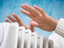 Female hands above the heater stock photo Female hands above the heater stock photo
