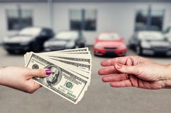Female hands with dollar banknotes on background of cars row royalty free stock photos Female hands with dollar banknotes on background of cars row royalty free stock photos