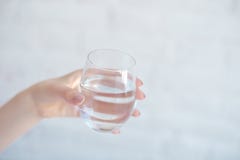 Female hands holding a clear glass of water. royalty free stock photos Female hands holding a clear glass of water. royalty free stock photos