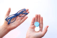 Female hands holding spectacles and contact lenses and choosing royalty free stock image Female hands holding spectacles and contact lenses and choosing royalty free stock image