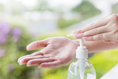 Female hands using wash hand sanitizer gel pump dispenser. Stock Photos Female hands using wash hand sanitizer gel pump dispenser. Stock Photos