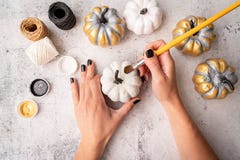 Female Hands With Black Nails Painting Pumpkins For Halloween Stock Images