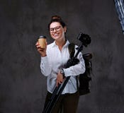 Female Holds Digital Photo Camera And Takeaway Coffee Over Grey Background. Stock Images Female Holds Digital Photo Camera And Takeaway Coffee Over Grey Background. Stock Images