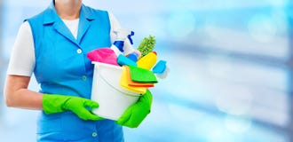 Female cleaner holding a bucket with cleaning supplies stock photography Female cleaner holding a bucket with cleaning supplies stock photography