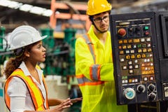 Female Industrial Engineer Standing In A Heavy Industrial Factory Stock Photo