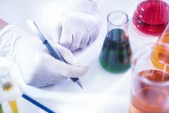 Female Laboratory Worker Dealing With Flasks Containing Liquid Chemicals Stock Photo Female Laboratory Worker Dealing With Flasks Containing Liquid Chemicals Stock Photo