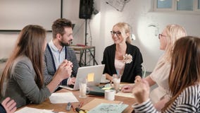 Female leader reported good news, everyone is happy, high-fiving each other business team in a modern startup office. Stock Photos Female leader reported good news, everyone is happy, high-fiving each other business team in a modern startup office. Stock Photos