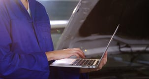 Female mechanic using laptop
