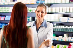 Female pharmacist in her pharmacy with a client Royalty Free Stock Photos Female pharmacist in her pharmacy with a client Royalty Free Stock Photos